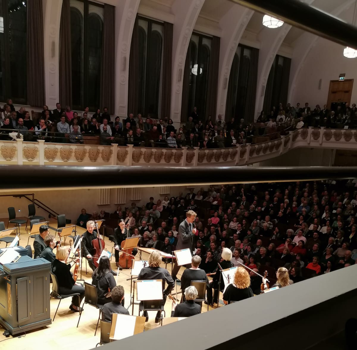 Orchestra and audience playing and listening at a concert