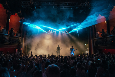 Band on stage with lights and audience