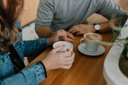 Man And Woman Having Lattes