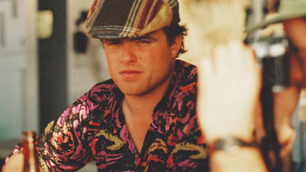 Image of Charlie Waller wearing a flat cap and looking into the distance