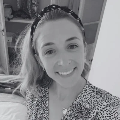 A black and white photo of Beth, a young woman smiling at the camera A black and white photo of Beth, a young woman smiling at the camera