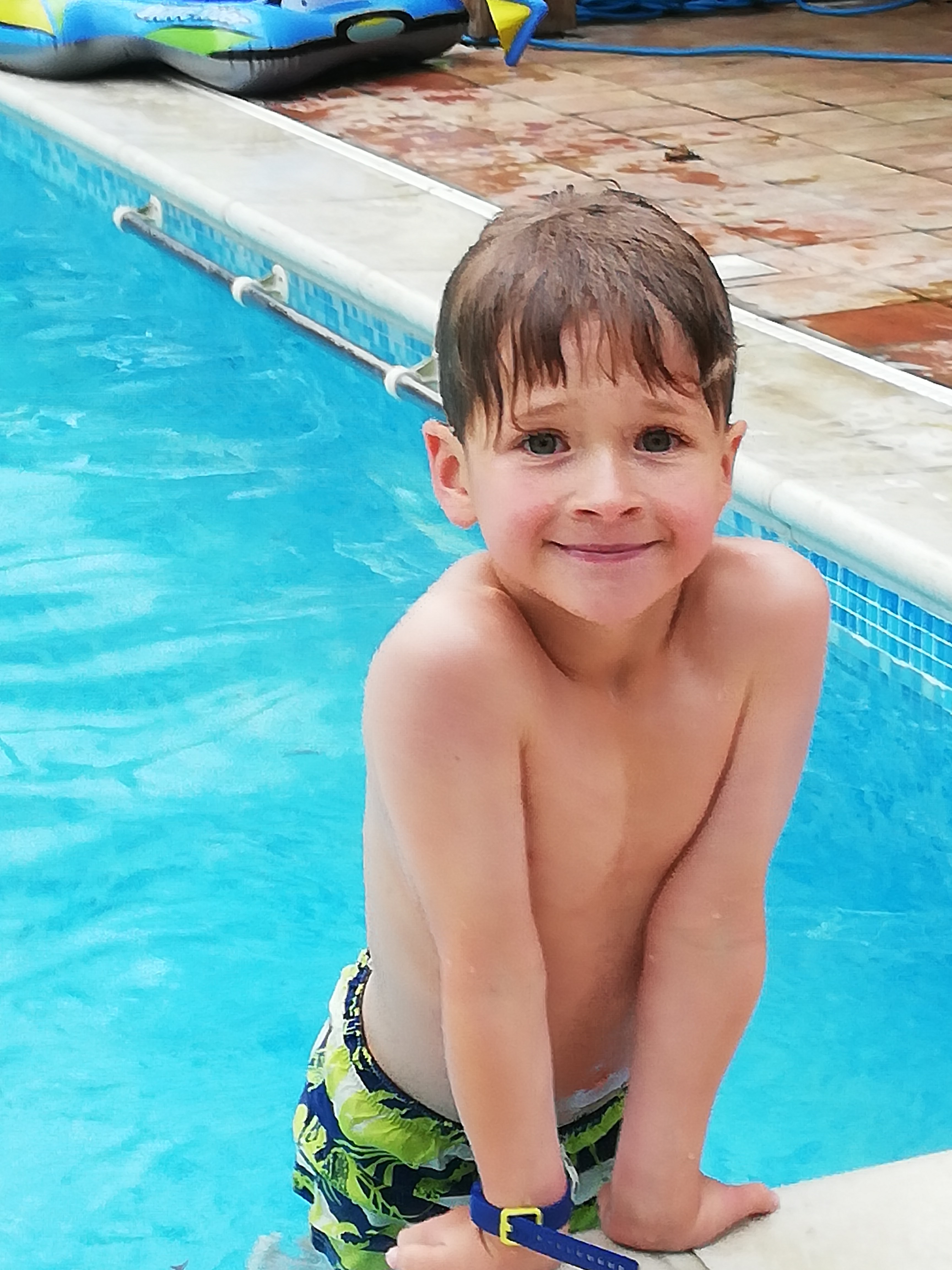 Happy boy in swimming pool