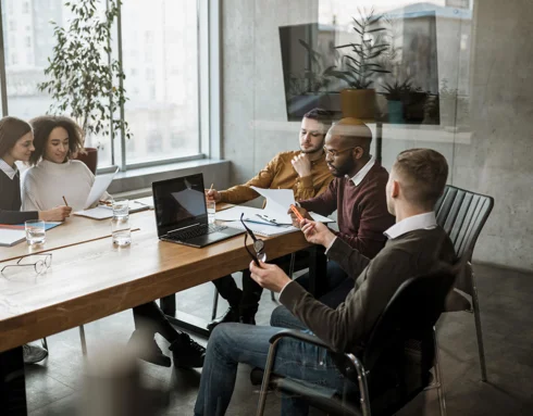 Front view of people having a meeting in an office