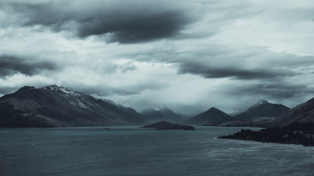 Mountains with sea and dark, cloudy sky