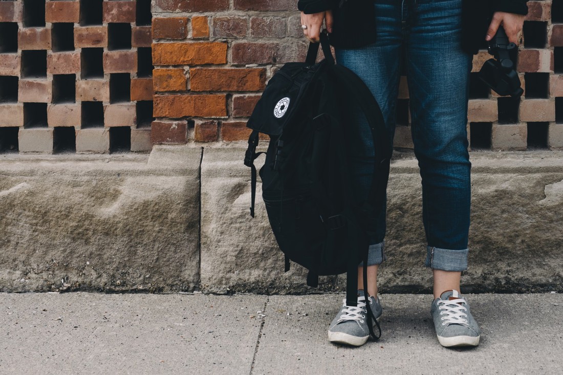 Student's legs and school bag 