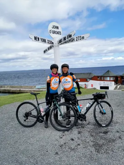 Beth and Harry in front of John O'Groats sign