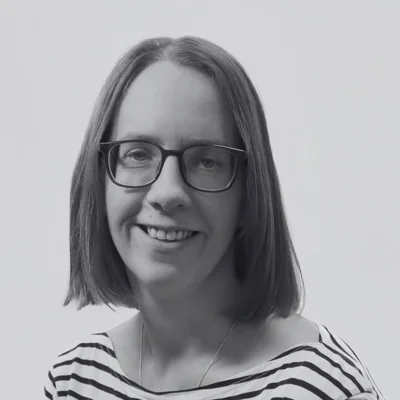 Carrie, a white woman with short brown hair smiling at the camera Carrie, a white woman with short brown hair smiling at the camera
