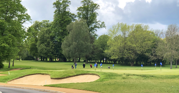 Golf player hitting ball