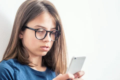Young girl looking at a smart phone