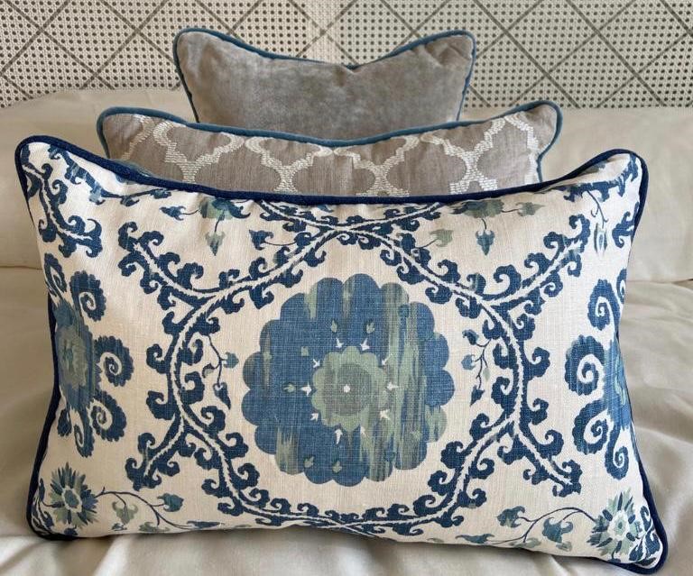 blue cushions displayed on bed