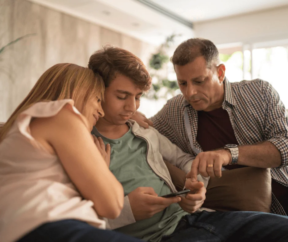 Family Looking Over Boys Shoulder