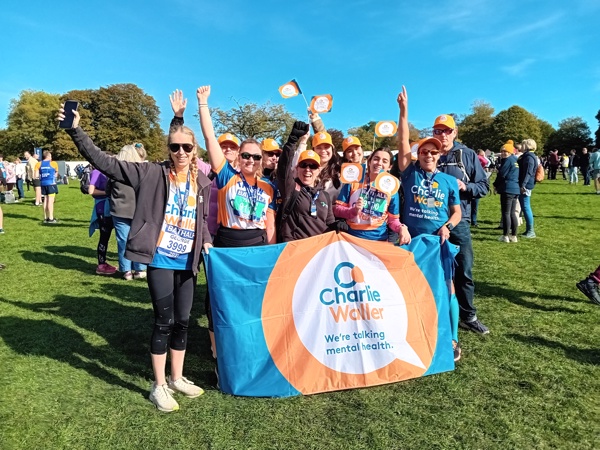 Bath Half participants holding a Charlie Waller Trust banner