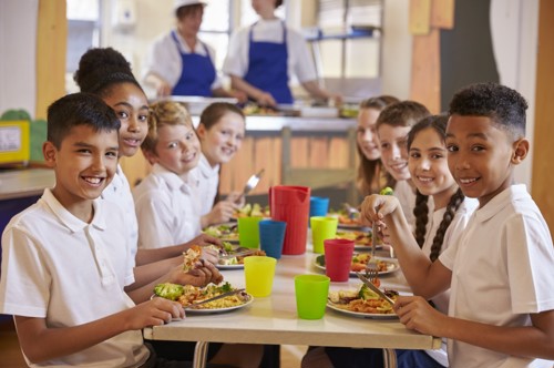 children smiling at lunch table