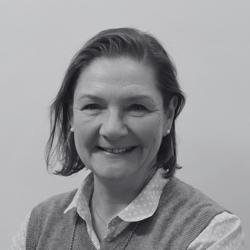 Helen, a woman with short hair smiling at the camera