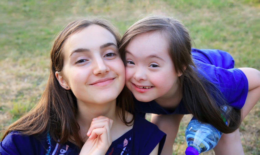 Two young girls smiling 