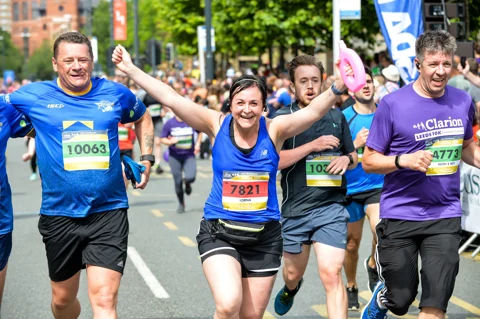 Marathon runners holding hands in the air Marathon runners holding hands in the air