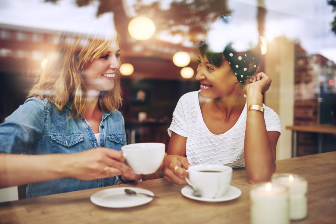 Two woman having coffee together 