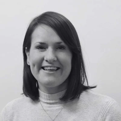 Angela, a woman with short hair smiling at the camera. Angela, a woman with short hair smiling at the camera.