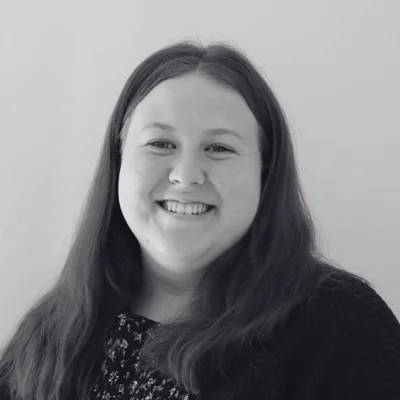 Emily, a woman with long hair smiling at the camera Emily, a woman with long hair smiling at the camera