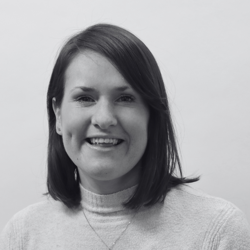 Angela, a woman with short hair smiling at the camera.