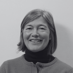 Lucy, a woman with short hair smiling at the camera