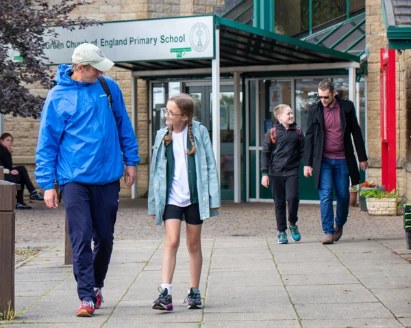 Father and daughter leaving a primary school 
