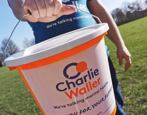 CWT Donation bucket being held by a man in a CWT tshirt