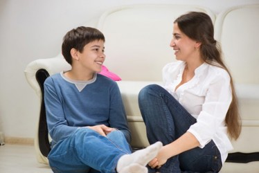 Child and mother smiling at each other