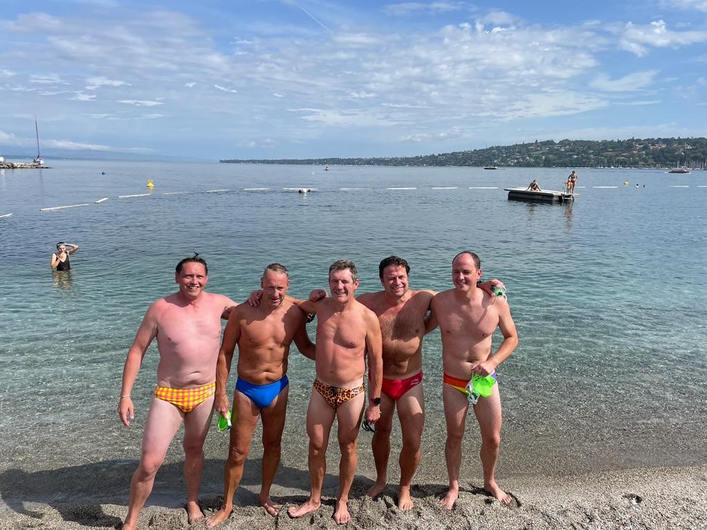 Swimming team the Broker Buoys smiling at the finish of the Geneva 70