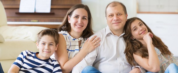 Family sat down and smiling 