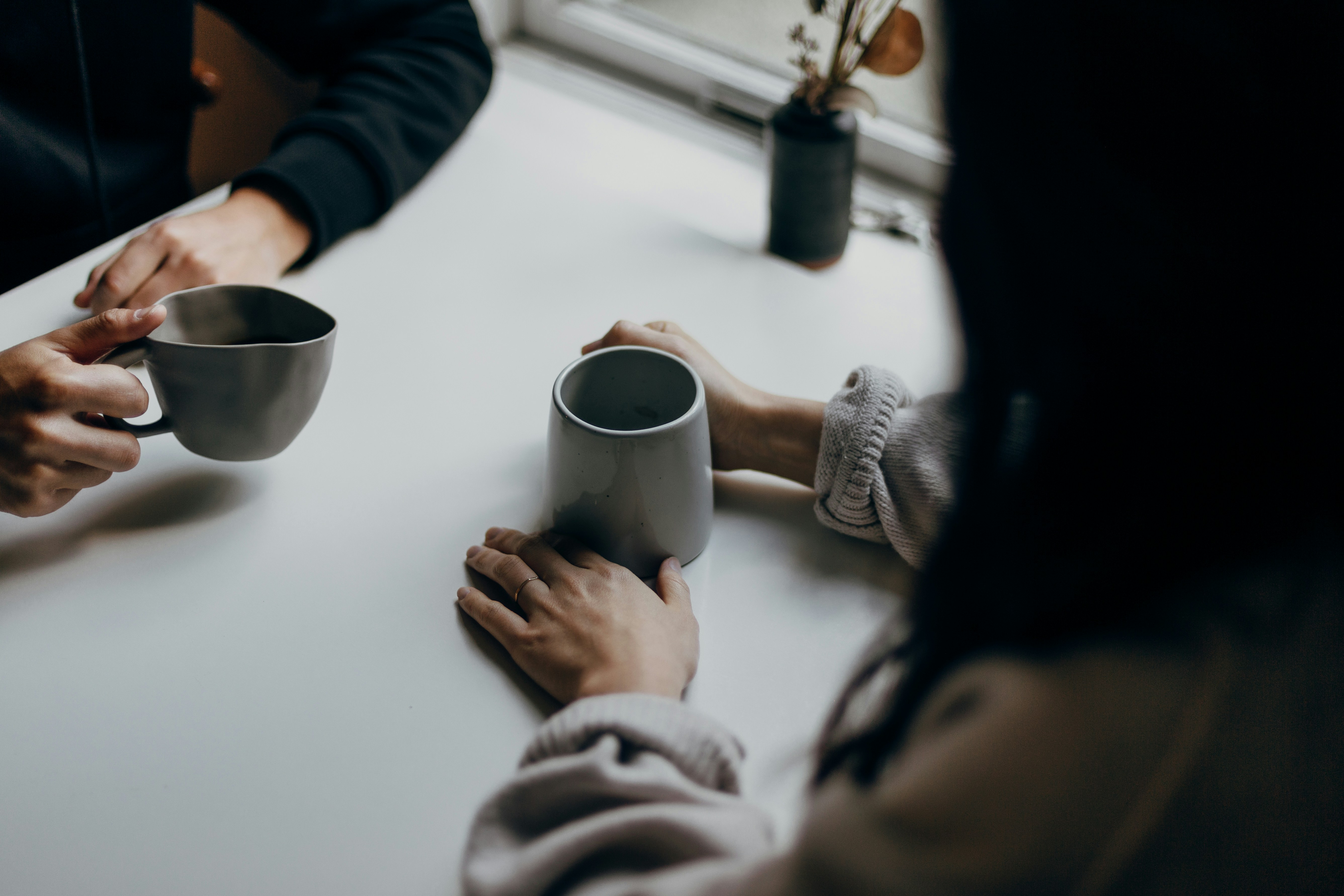 Two people having coffee - faces not visible