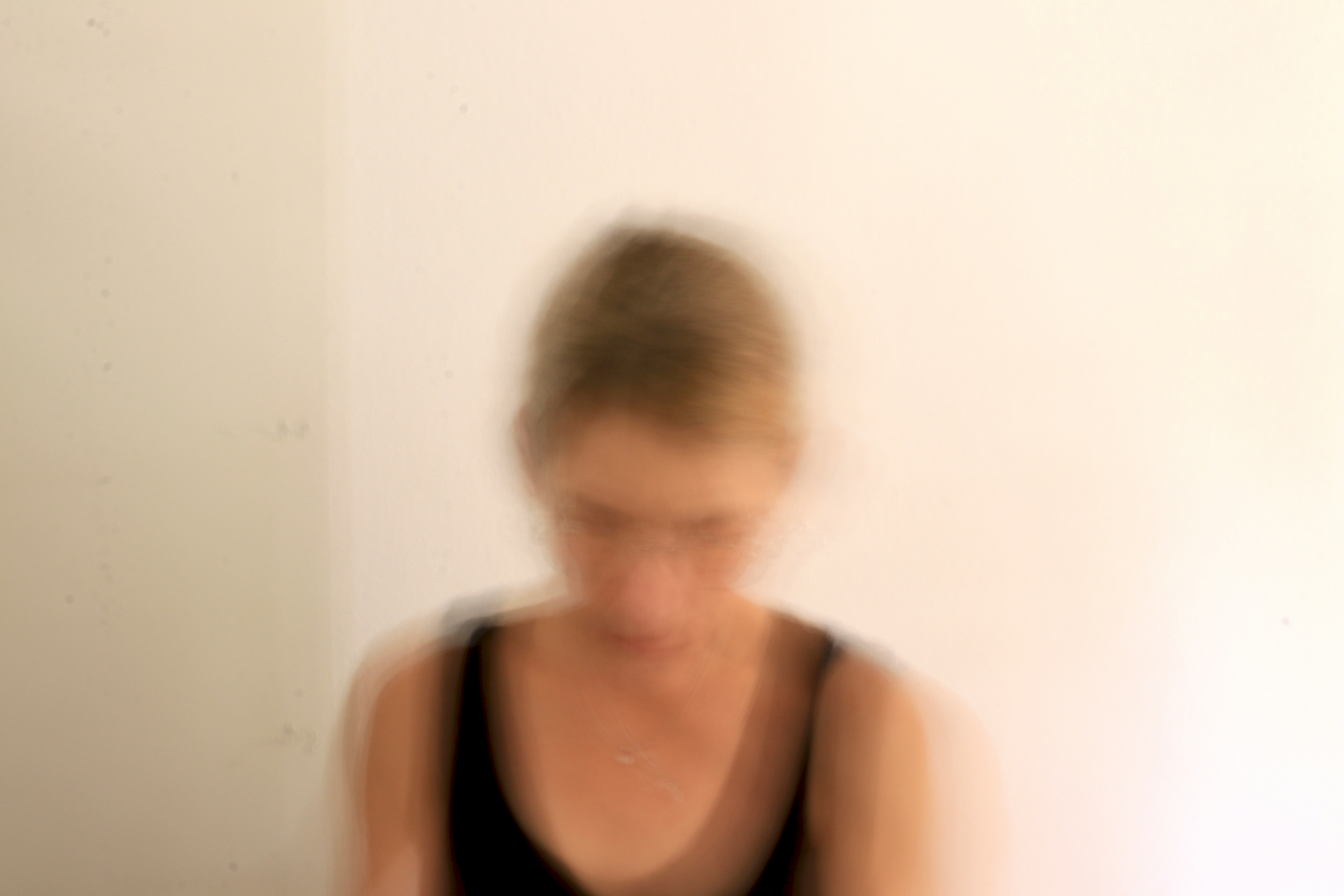 Blurred face of young person, looking downward